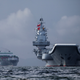 The Liaoning (right) arrives in Hong Kong on July 7.